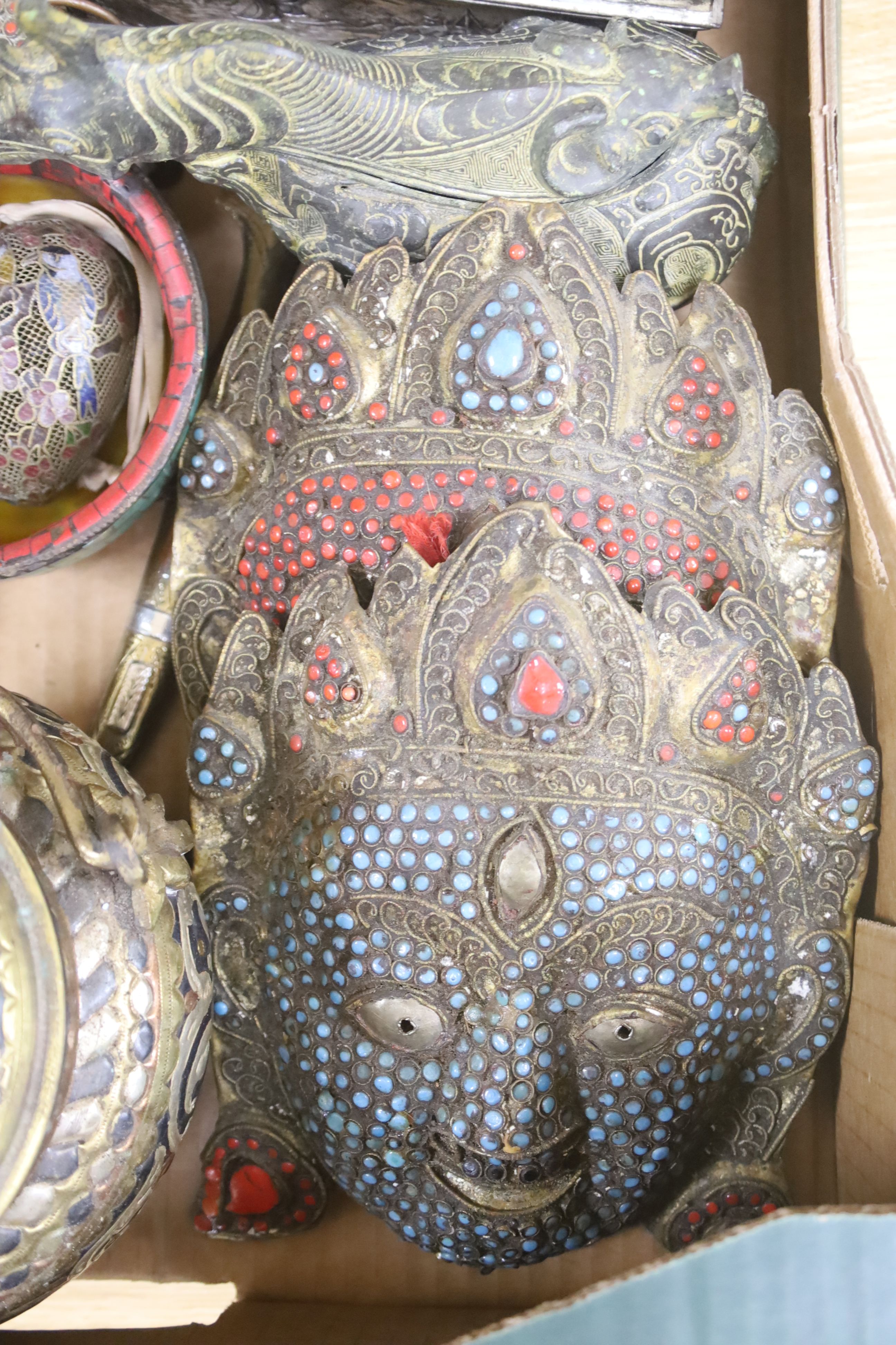 A group of Tibetan style metalware figures, masks, ornaments, etc.